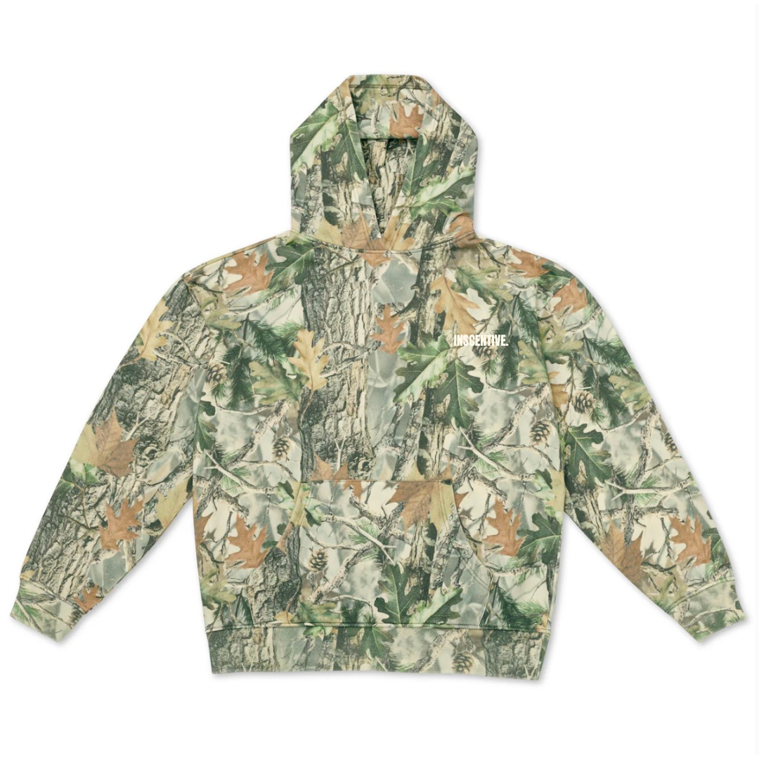 INSCENTIVE camouflage hoodie – unisex streetwear pullover with bold white logo text, forest camo print, and front pocket.
